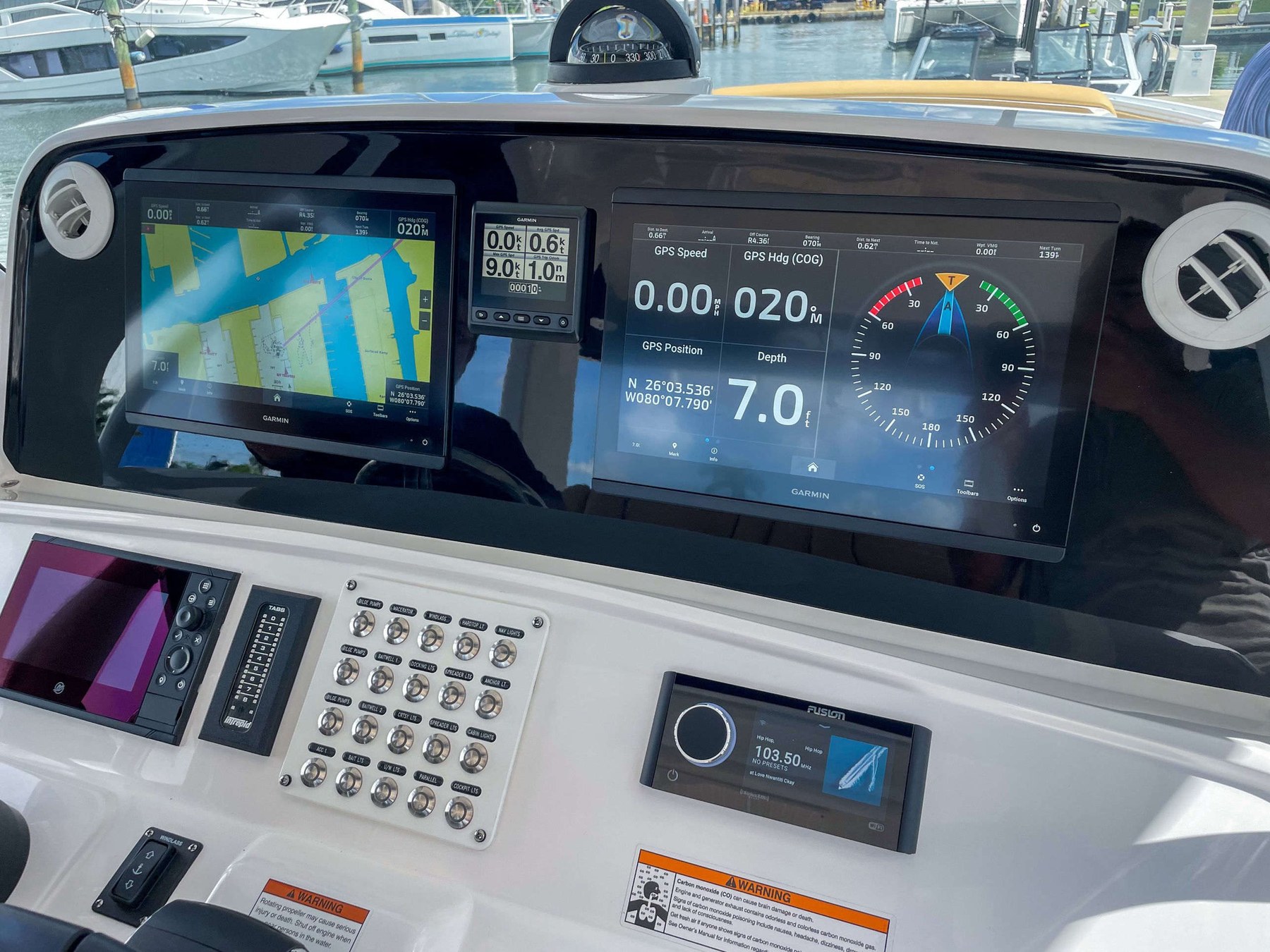 Blacked-out dash with dual Garmin plotters, dual gauges, and a custom switch panel