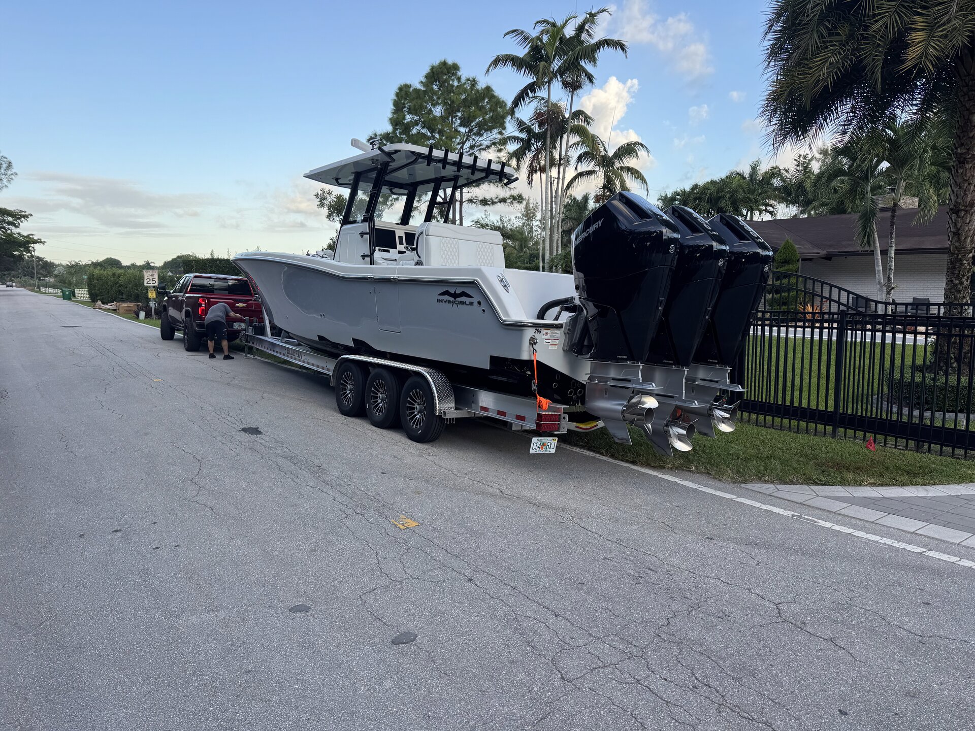 Invincible with triple black Mercury outboards on trailer